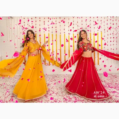 A dynamic shot for the SHREE Autumn Winter '24 collection, capturing the movement and vibrant colors of festive lehengas. The falling petals add a celebratory feel, perfect for a seasonal campaign.