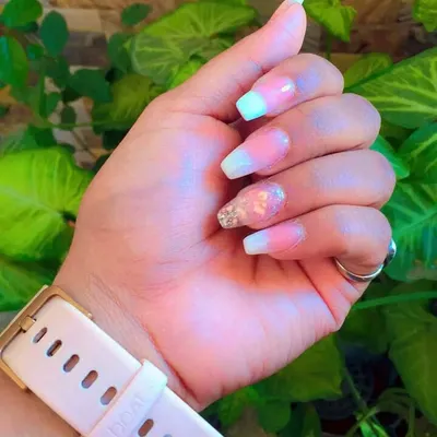 An excellent example of a student mastering multiple techniques. This set combines a soft pink and mint green ombre, a classic French tip style, and an accent nail with carefully placed dry flowers.
