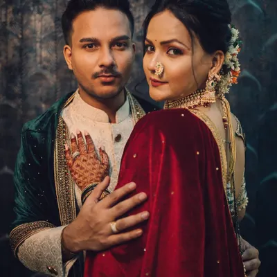 A powerful and intimate royal-themed couple portrait, showcasing a deep connection with moody, cinematic lighting and rich, traditional attire.
