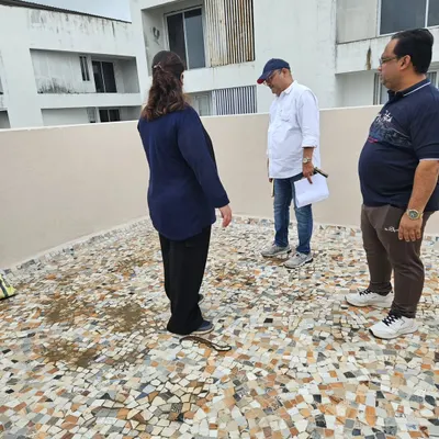 Consulting with clients on the terrace of their home. Even outdoor spaces like balconies and terraces have Vastu significance and impact the home's overall energy.