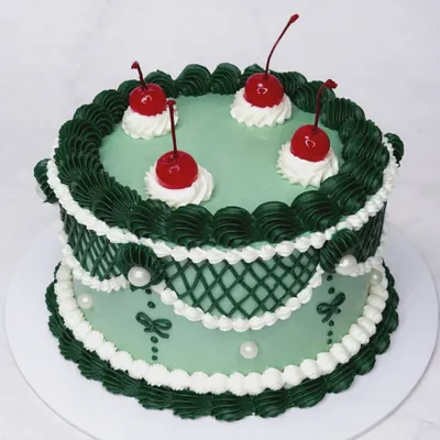 Lambeth cakes are the best, aren't they? And I do them the best too. This green vintage cake with dark green lattice piping and cherries is Instagram-perfect and tastes divine.