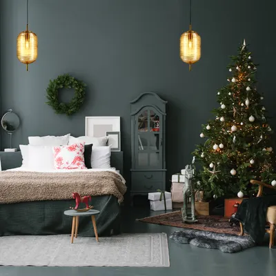 This Christmas, I helped this client bask in the glow of timeless luxury. The two amber glass pendants add a warm, festive touch to their cozy bedroom, illuminating their celebrations.