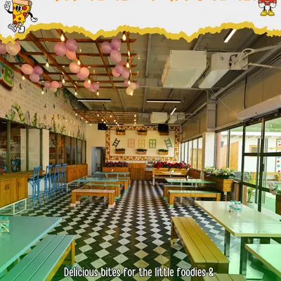 A look inside our spacious and vibrant cafe area. With plenty of seating, it's the perfect spot for parents to relax with a coffee while the kids play, and where everyone gathers for delicious party food.