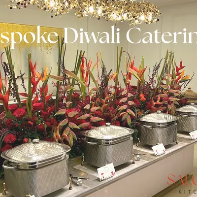 A bespoke Diwali catering setup featuring a stunning floral centerpiece and elegant silver chafing dishes. I design each buffet to be a feast for the eyes as well as the palate.