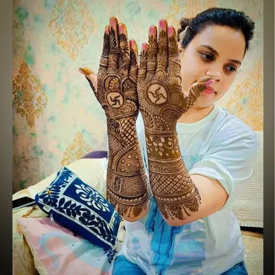 A beautiful Karva Chauth or Diwali mehandi design featuring the auspicious swastika symbol in the center of the palms. The design is full and intricate, perfect for a grand festive celebration.