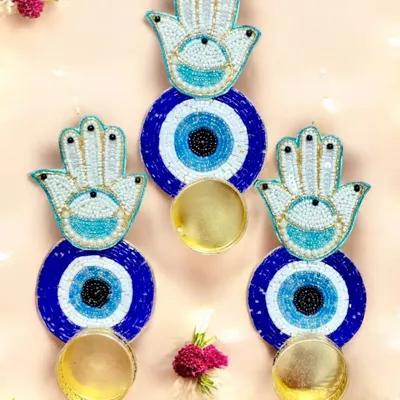 These Hamsa Hand and Evil Eye wall hangings with attached diya holders are perfect for warding off negativity. They are a beautiful and meaningful addition to any festive decor or as a thoughtful gift.