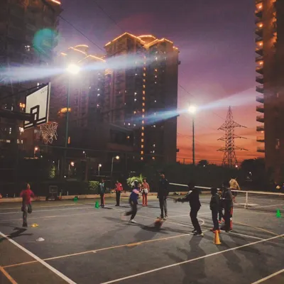A wide view of our main outdoor court at Kunskapsskolan in DLF Phase 1. It's an international standard court with excellent floodlighting for night games.
