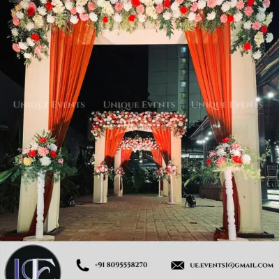 A grand entrance sets the tone for the entire event. This layered archway, decorated with florals and fabric, creates a beautiful passageway for guests, making their arrival a memorable experience.