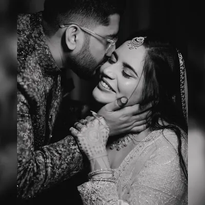 A beautiful black and white close-up of Aditya kissing Jini's forehead during their engagement session. This timeless photo focuses purely on the emotion and connection between the couple.