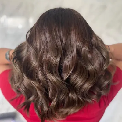 This glossy ash-brown is a perfect example of a modern, chic global color. The cool tones are expertly blended to create a sophisticated look, and the hair is left feeling incredibly soft and looking super shiny.