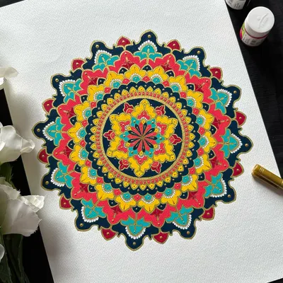 A close-up of a stunning ornate mandala. The combination of deep blues, radiant yellows, and rich reds creates a feeling of royalty and celebration. This is a style I absolutely love teaching.