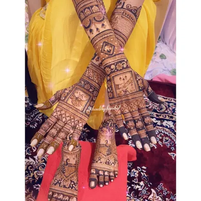 A complete bridal mehendi set. This shows the fully adorned hands and feet, featuring family portraits, traditional motifs, and intricate fill-work for a truly grand look.