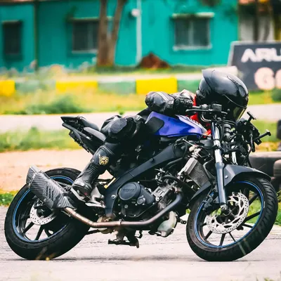 Here, a rider practices a deep lean, a core skill for advanced cornering. We teach you how to build up to this level of control safely, ensuring your bike and body work together as one.