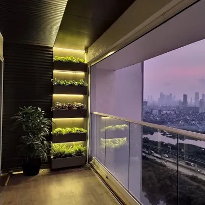 We designed and installed this illuminated vertical planter system for a high-rise residence in Mumbai. This setup is perfect for balconies, creating a green sanctuary with a stunning city view, and uses plants that thrive in apartment conditions.