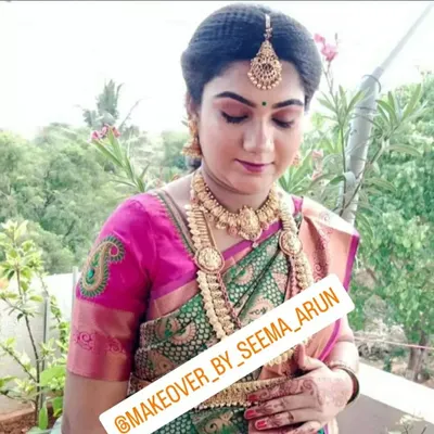 A serene and beautiful makeover for a baby shower. The makeup is soft and glowing, and the look is completed with traditional jewellery and a perfectly draped silk saree.