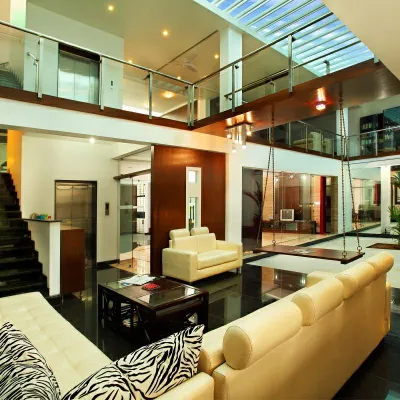 This residence is a contemporary interpretation of a traditional courtyard home. The central, sky-lit space acts as the heart of the house, with all rooms organized around it to maximize light and maintain a constant visual connection.
