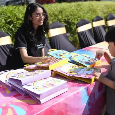 Our team is involved in every step of the process. Here, a team member organizes craft kits and return gifts at a kids' pool party, ensuring every little guest leaves with a smile and a special memento.