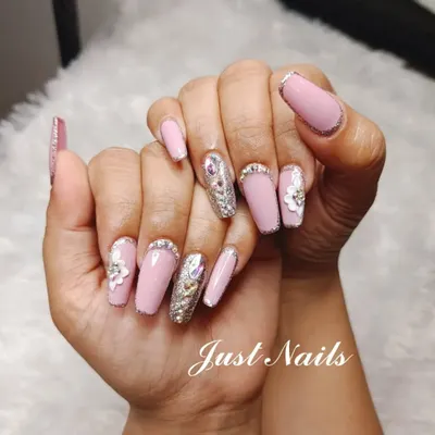 A truly glamorous set featuring pink coffin nails with silver glitter accents, 3D flowers, and a full-coverage silver glitter nail with a large crystal centerpiece. This is a statement look for a bride who wants maximum sparkle.