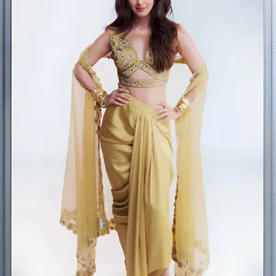 The radiant Kiara Advani looking effortlessly chic in the golden Lydia Cape Set. The modern dhoti-drape skirt and embellished blouse create a perfect fusion look.