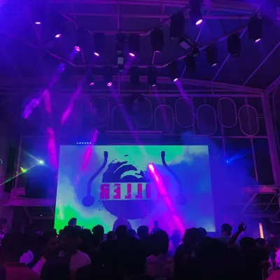 The club is washed in purple light as the beat drops. The right lighting and haze create an atmosphere where people can lose themselves in the music.