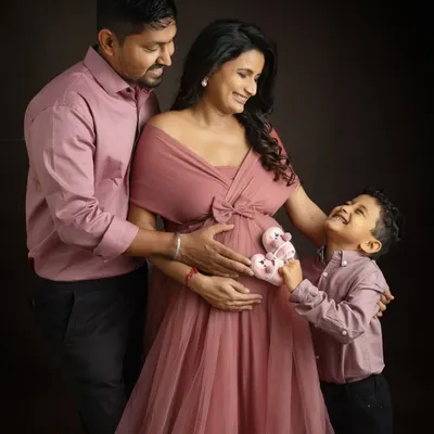 The big brother is ready for his new role. Having him hold the tiny baby shoes to the bump is such an adorable way to capture his excitement for the new arrival.