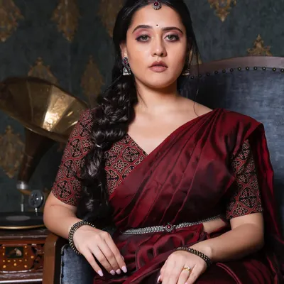 A royal and majestic look for actress Vedangi Kulkarni. This styled shoot features a deep maroon saree, a braided hairstyle, and bold, expressive makeup.