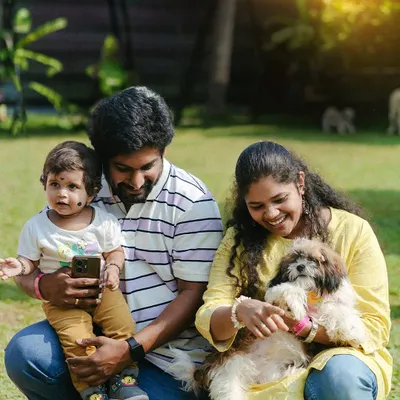 A happy family with their child and pet. We're a place where the whole family, including the little ones, can have fun.
