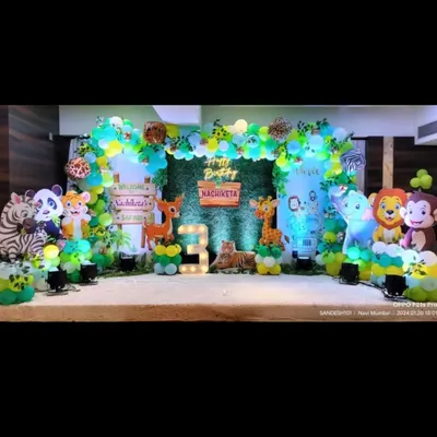 A vibrant jungle safari theme for a 3rd birthday. This stage features a variety of cute animal cutouts, a lush green backdrop, and a wooden sign, creating a welcoming and fun atmosphere for the little explorer.
