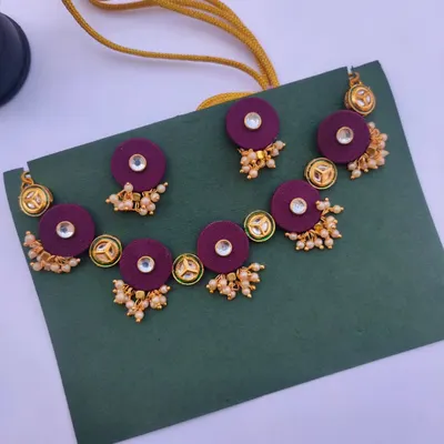 This beautiful kundan necklace set is made with deep purple fabric patches and delicate pearl clusters. I can customise the colour of the fabric to match your wedding or party outfit.