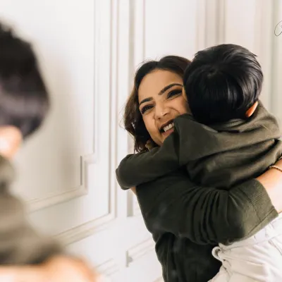 A warm embrace from your child is like holding your entire world in your arms. This candid moment, reflected in the mirror, adds a layer of intimacy and tells a story of pure, unconditional love.
