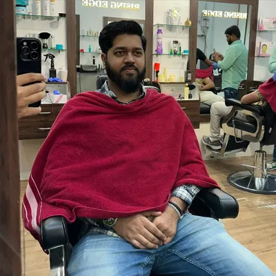 Dapper and delighted. A happy client relaxing in the chair after his grooming session, reflecting the comfortable experience I strive to provide.