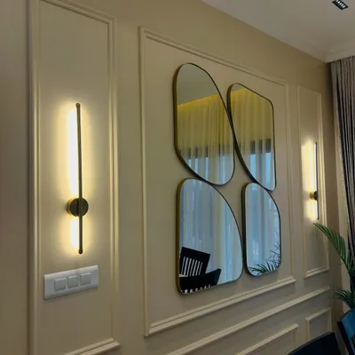 This dining space is a beautiful fusion of classic and modern styles. The Victorian-inspired wall molding is paired with sleek, contemporary mirrors and elegant wall sconces, creating a sophisticated backdrop for the dining table.