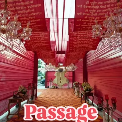 This grand passage is designed for a traditional ceremony, draped entirely in red fabric printed with sacred mantras. The crystal chandeliers and a divine statue at the end create a deeply spiritual and opulent pathway.