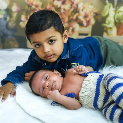 The beginning of a lifelong friendship. Capturing the gentle love between an older brother and his new baby sibling is one of our favorite moments.