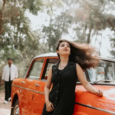 A cinematic portrait of the bride-to-be leaning against a vintage car, her hair caught in the wind. This shot has a cool, free-spirited vibe that I love to capture.