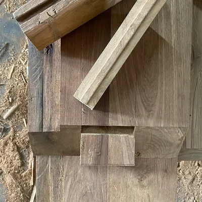 A detailed look at the wood joinery for a piece of custom furniture. This image shows the precision of a half-lap joint, a technique we use to ensure strength and durability in our bespoke designs.