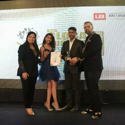 Receiving a trophy at the 5th Global Business Leadership Awards, a recognition of our contribution to the industry.