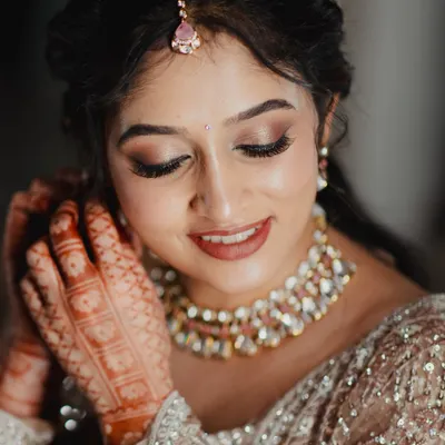 A close-up of a soft glam reception look. I used warm, shimmery eyeshadows and a neutral pink lipstick to create a romantic and modern feel that enhances her natural features without feeling heavy.