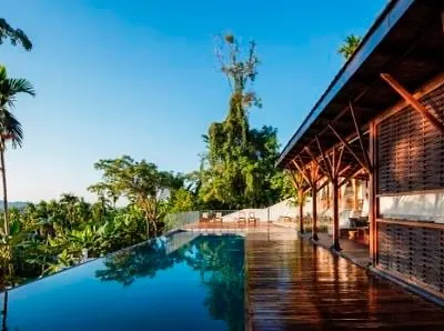 The infinity pool at Jalakara, a boutique hotel we designed and built in the Andaman Islands. The pool deck overlooks the dense rainforest, showcasing our philosophy of creating luxury experiences that are deeply immersed in nature.