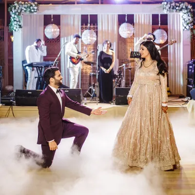 A classic romantic pose to start the performance. We choreograph beautiful moments like this groom's proposal mid-dance, set against a live band and a smoky floor for that extra dreamy effect.