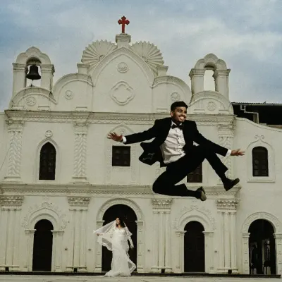 The pure joy of a 'just married' moment. I love capturing this kind of spontaneous energy, like the groom's celebratory jump outside the church. It's these real, unposed moments that you'll cherish.