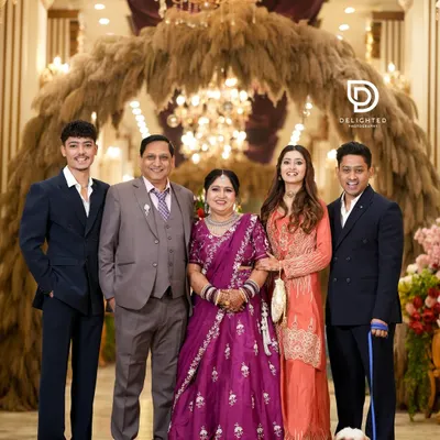 A beautiful family portrait taken at a 25th-anniversary celebration. It captures three generations and even the family pet, all gathered to honor the happy couple.