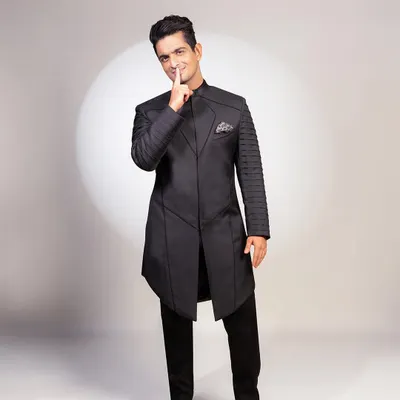 For Anant and Radhika's wedding festivities, I designed this 'superhero' inspired achkan set for Ranveer Allahbadia. The structured panels and pleated sleeves create a powerful, futuristic silhouette.