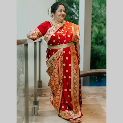 The beautiful mother of my Bengali bride, looking absolutely regal in her traditional red and gold saree. We gave her a classic makeup look with a defined eye, a red bindi, and an elegant hair bun to complete her look.