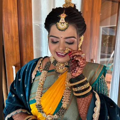 My beautiful bride looking regal in her Nauvari. The look is complete with a 'jodvi' on her forehead, a classic 'nath', and subtle yet glowing makeup that highlights her features.