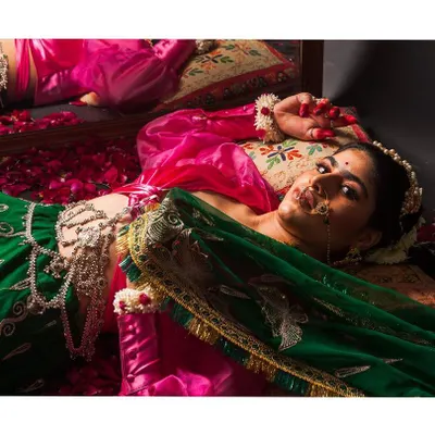 Our signature shot, inspired by Mughal art. This portrait combines rich colors, intricate jewelry, and dramatic lighting to create a piece that feels like a painting.