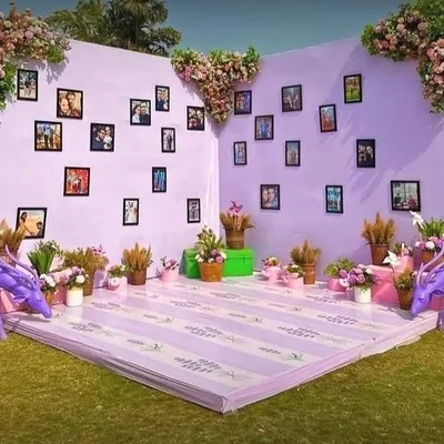 A whimsical lavender-themed selfie point for a wedding, complete with a photo gallery wall and cute purple deer props.