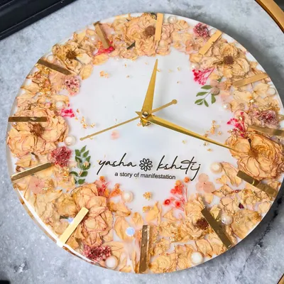 This 12-inch wall clock is a beautiful way to preserve your varmala. I arranged the couple's wedding flowers around the edge, with their names and a personal tagline, 'a story of manifestation', in the center.