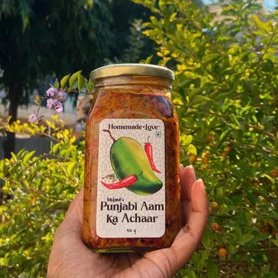 Our Punjabi Aam ka Achaar, held in the winter sun. This is our bestseller, made with a traditional recipe that has been in our family for generations. It's the perfect balance of spicy and tangy.