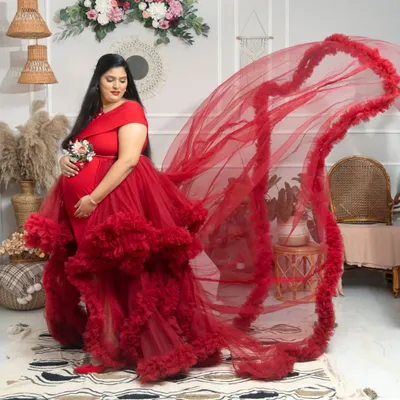 A glimpse of our stunning red ruffled gown with a dramatic flowing train, perfect for making a bold and beautiful statement.